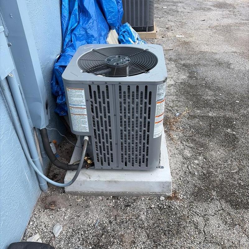 Air conditioning condenser on new concrete pad Air conditioning condenser on new concrete pad