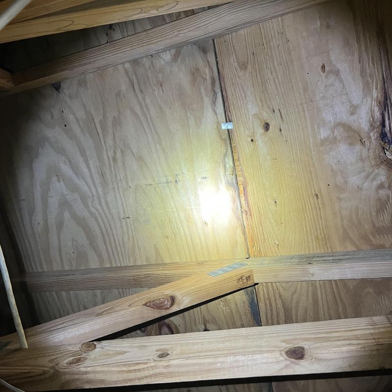 Plywood roof decking with wooden rafters in attic space Plywood roof decking with wooden rafters in attic space