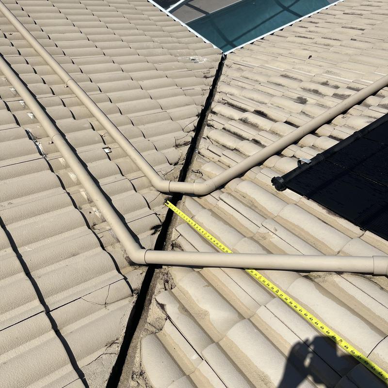 Tile roof valley with measuring tape and pipes Tile roof valley with measuring tape and pipes