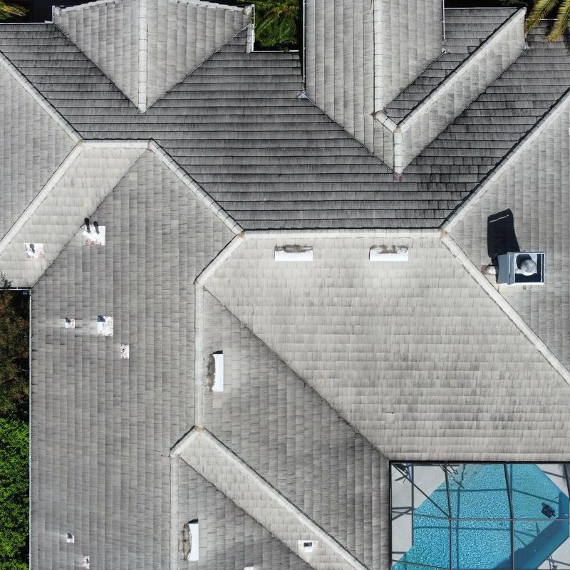 Shingle roof with multiple vents and skylights, aerial view Shingle roof with multiple vents and skylights, aerial view
