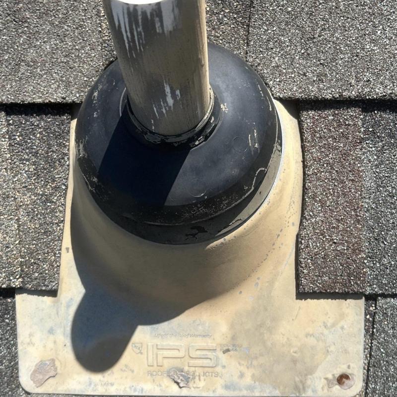 Roof pipe flashing with rubber boot on shingle roof