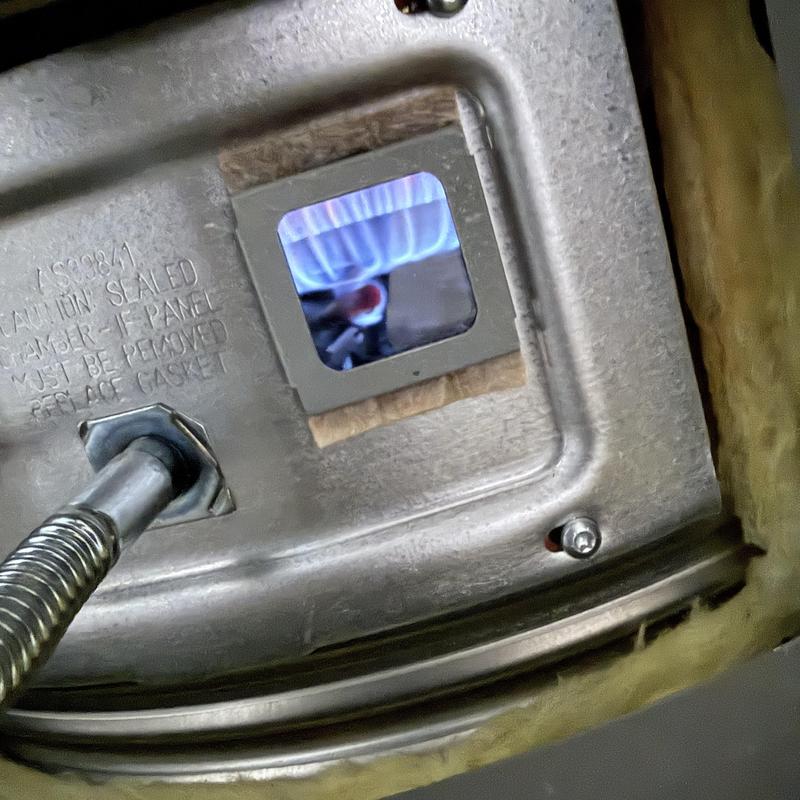 Water heater flame inspection through sight window