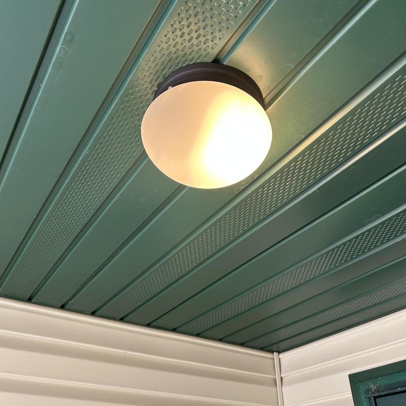 Exterior dusk-to-dawn light fixture on porch ceiling Exterior dusk-to-dawn light fixture on porch ceiling