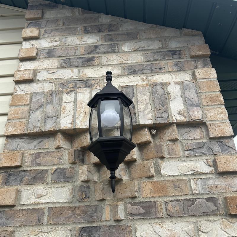 Exterior light fixture with dusk-to-dawn bulb on brick wall Exterior light fixture with dusk-to-dawn bulb on brick wall