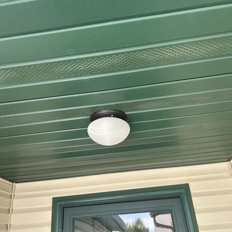 Exterior light fixture on green porch ceiling Exterior light fixture on green porch ceiling