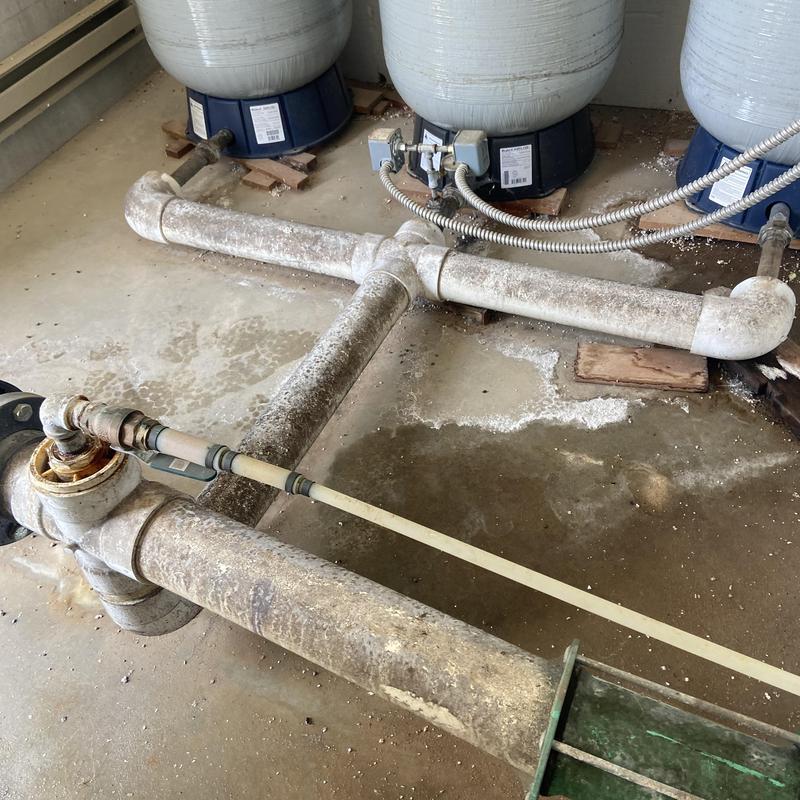 Community well waterline with pressure tanks and piping Community well waterline with pressure tanks and piping