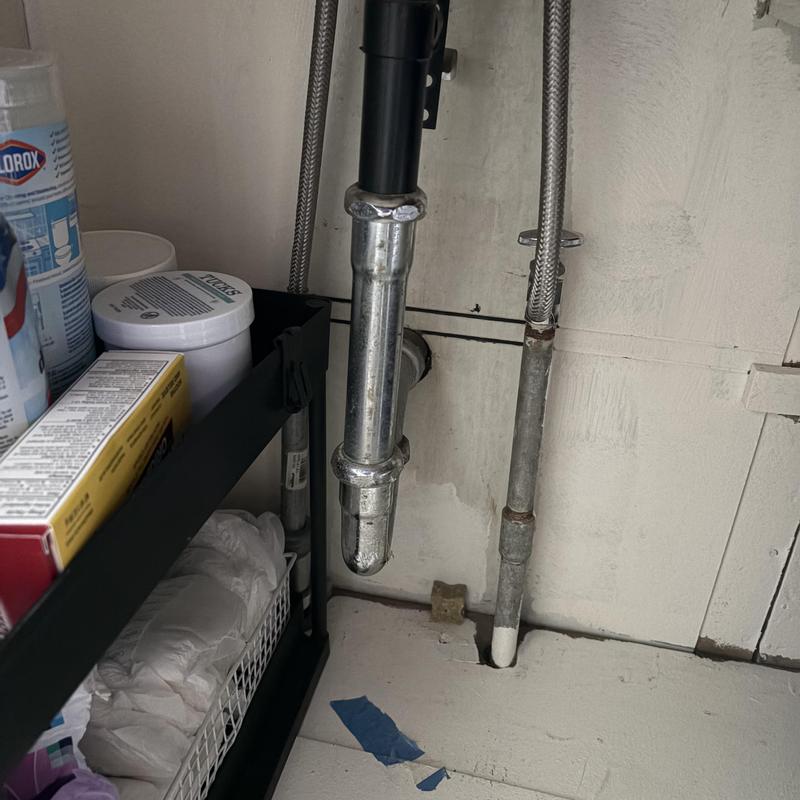Galvanized water piping and sink drain under kitchen cabinet Galvanized water piping and sink drain under kitchen cabinet