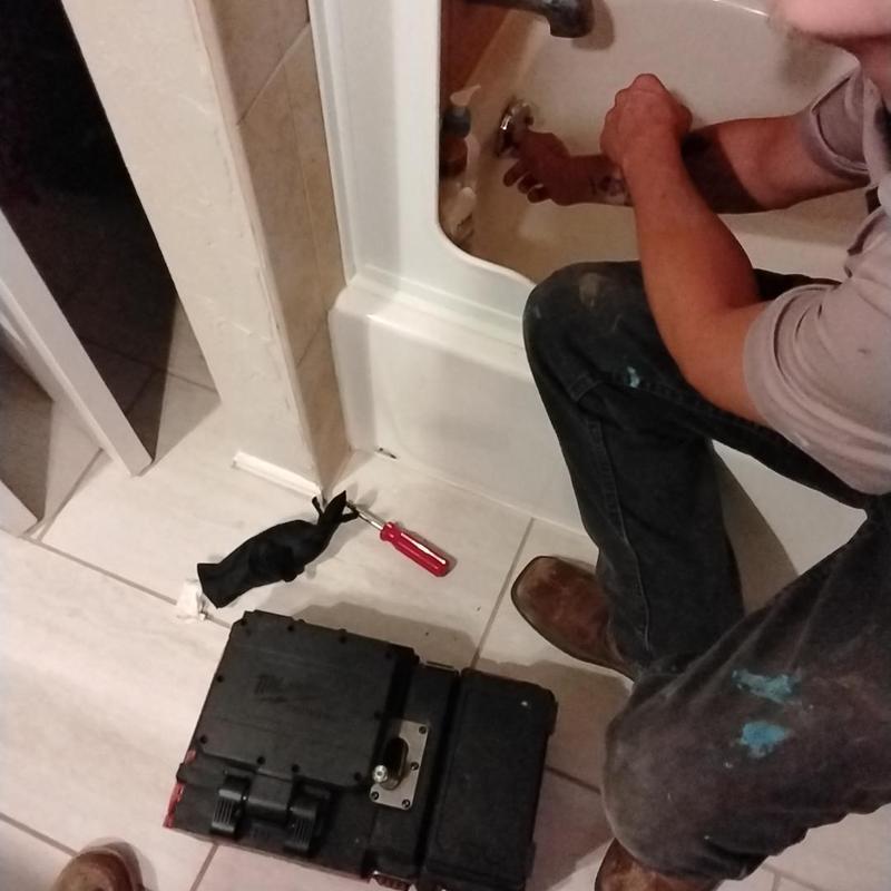 Bathtub drain valve inspection with plumbing tools Bathtub drain valve inspection with plumbing tools