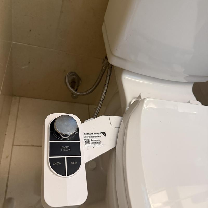 Toilet bidet control panel installation near tank