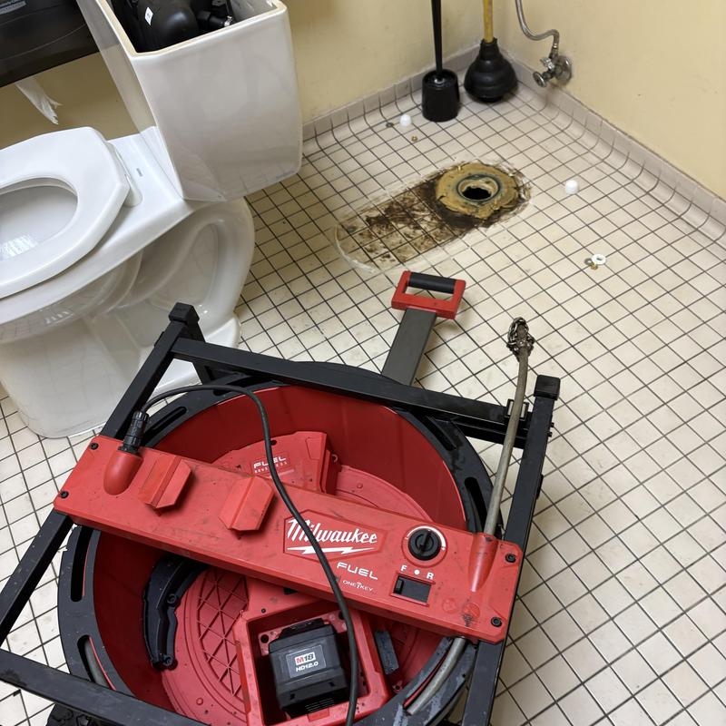 Main line drain with toilet removed and plumbing tools Main line drain with toilet removed and plumbing tools