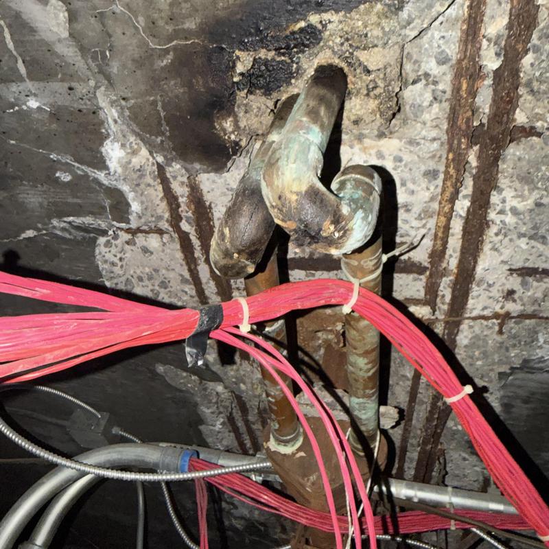 Copper plumbing pipes and electrical wiring under ceiling Copper plumbing pipes and electrical wiring under ceiling