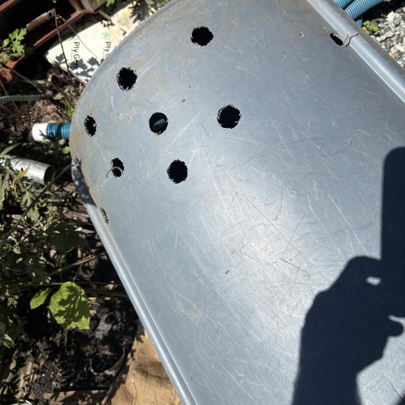 Septic tank lid with drilled ventilation holes outdoors Septic tank lid with drilled ventilation holes outdoors