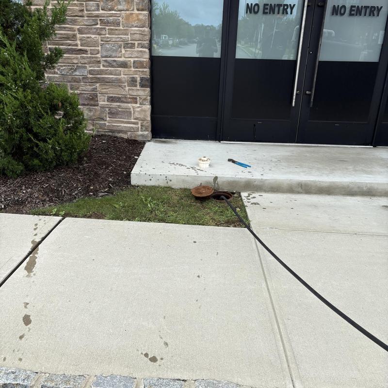 Main line sewer cleanout with hose and tools outside Main line sewer cleanout with hose and tools outside
