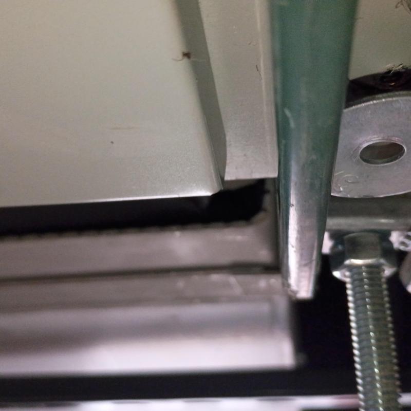 RTU metal panel gap near mounting bolt close-up RTU metal panel gap near mounting bolt close-up