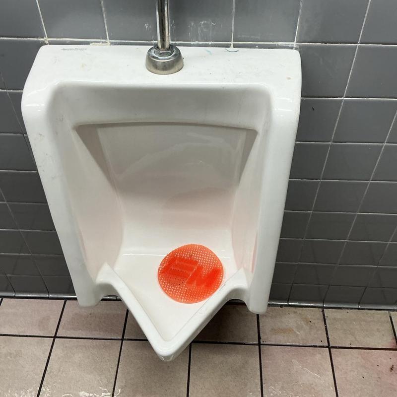 Urinal drain cleared and tested in restroom