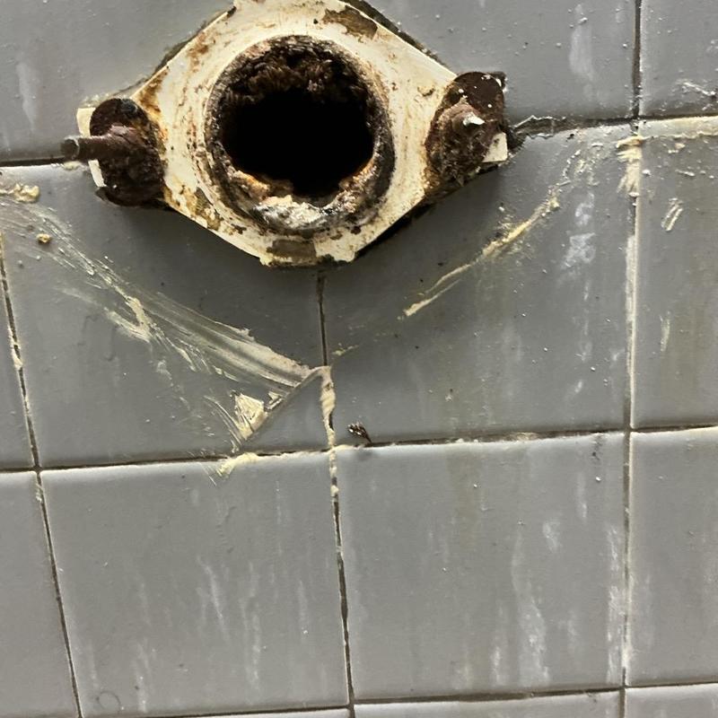 Urinal wall mount flange with rust and corrosion