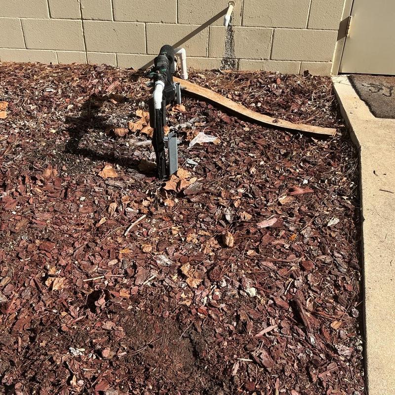 1-inch backflow preventer behind commercial building wall