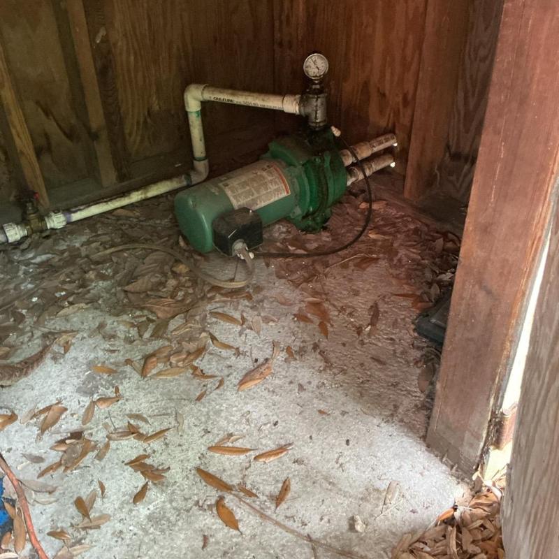 Water pressure pump with gauge in wooden enclosure
