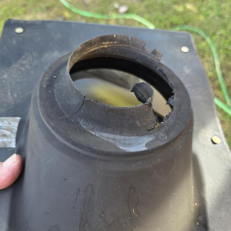 Damaged rubber roof pipe boot with torn edges Damaged rubber roof pipe boot with torn edges