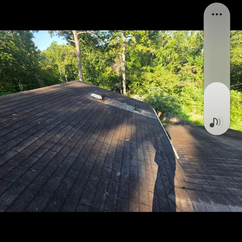 Asphalt shingle roof with patch and wear signs Asphalt shingle roof with patch and wear signs