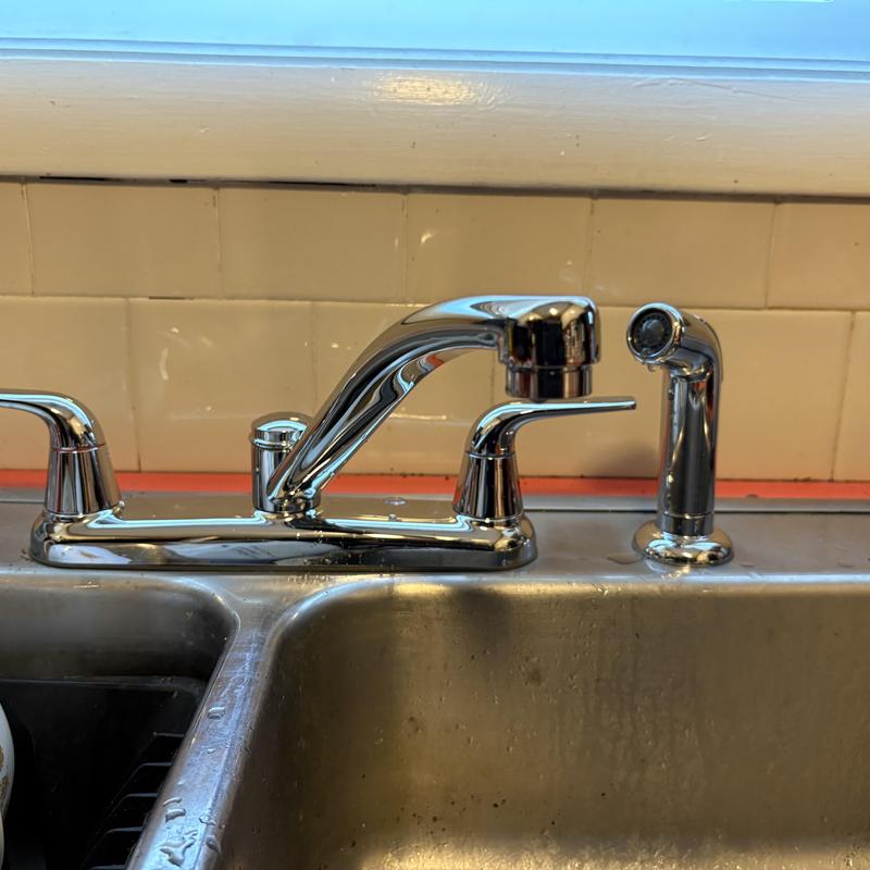 Kitchen faucet and sprayer installation on stainless sink