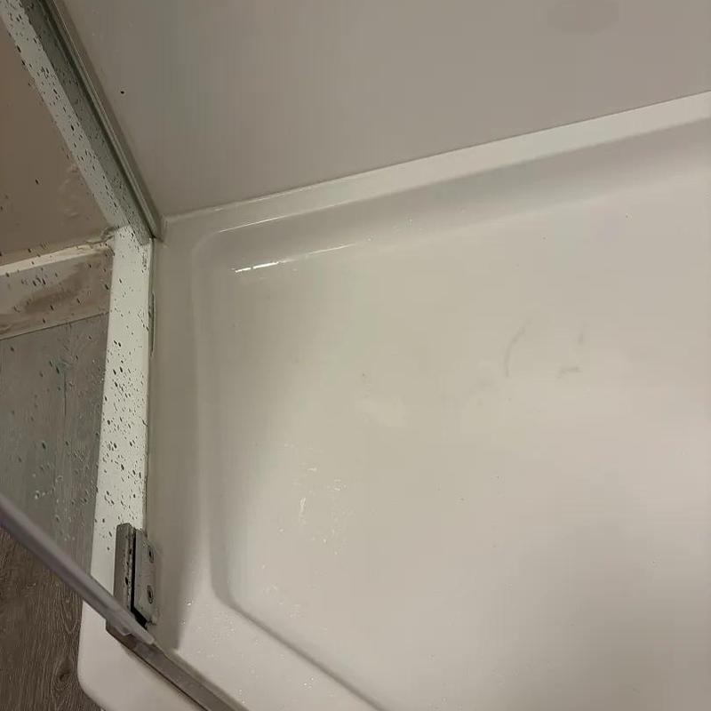 Shower base with resealed edges and glass door track