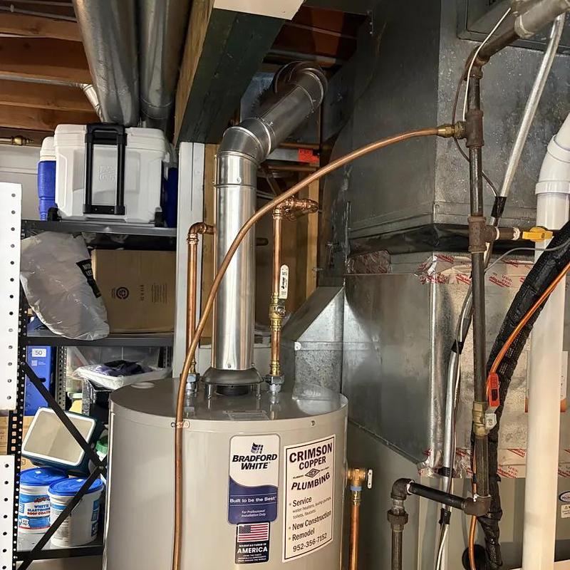 Water heater with vent pipe and copper plumbing