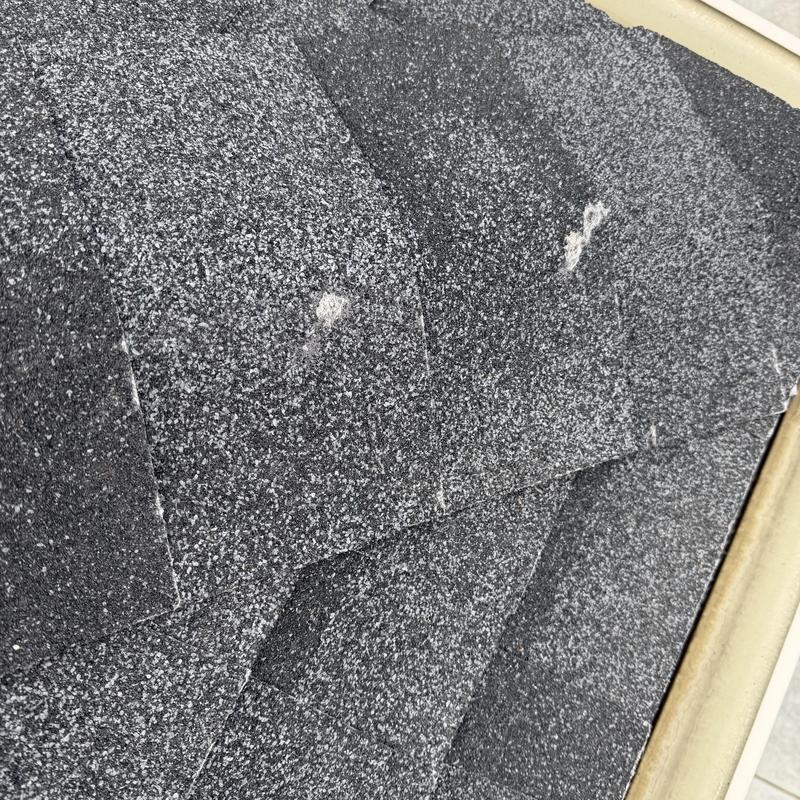 Asphalt roof shingles with hail damage spots Asphalt roof shingles with hail damage spots