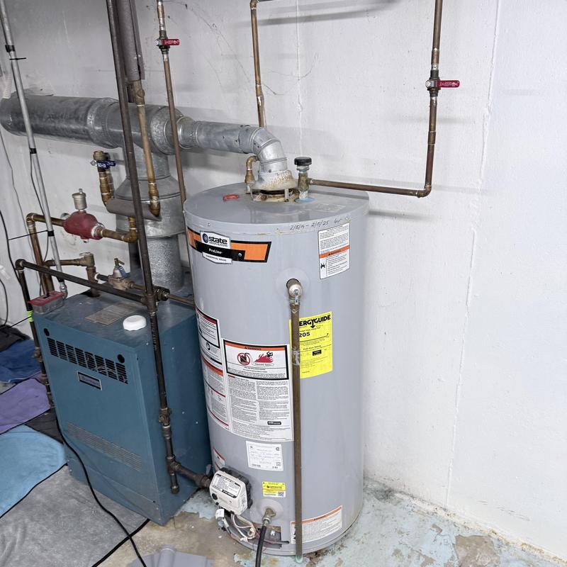 Electric water heater installation with plumbing connections Electric water heater installation with plumbing connections