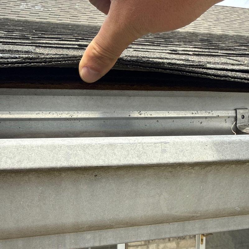 Asphalt shingle roofing lifted to inspect damage