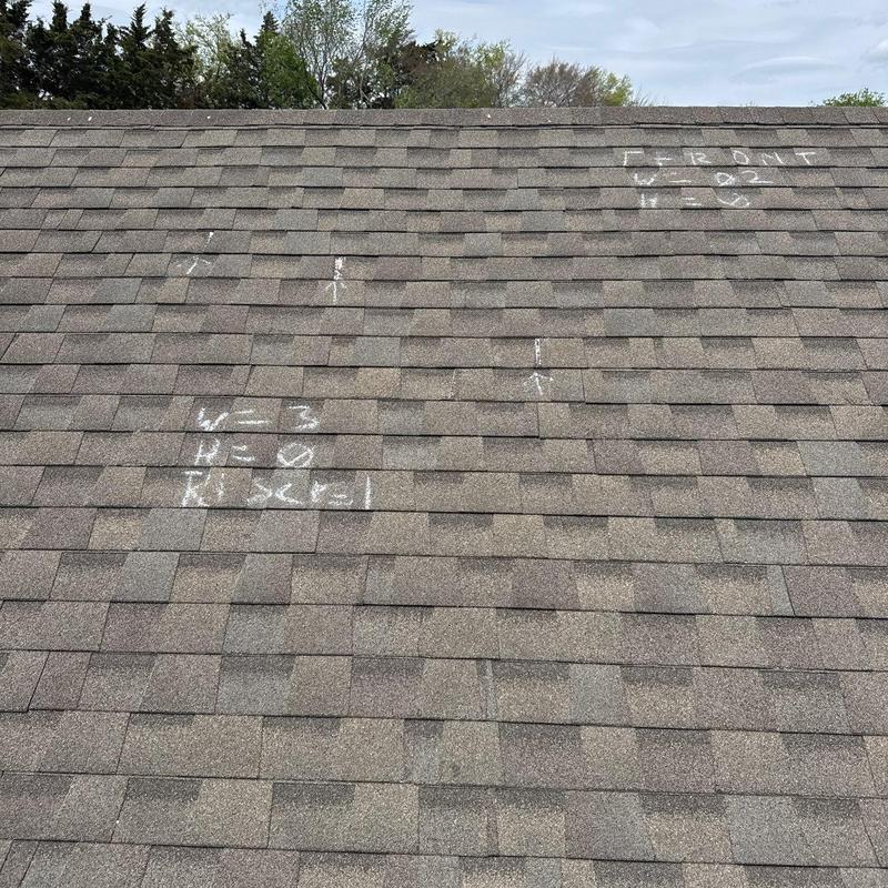 Roof shingles with marked hail damage spots