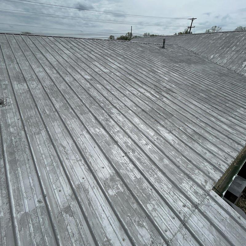 Metal roof panels with weathering and damage marks
