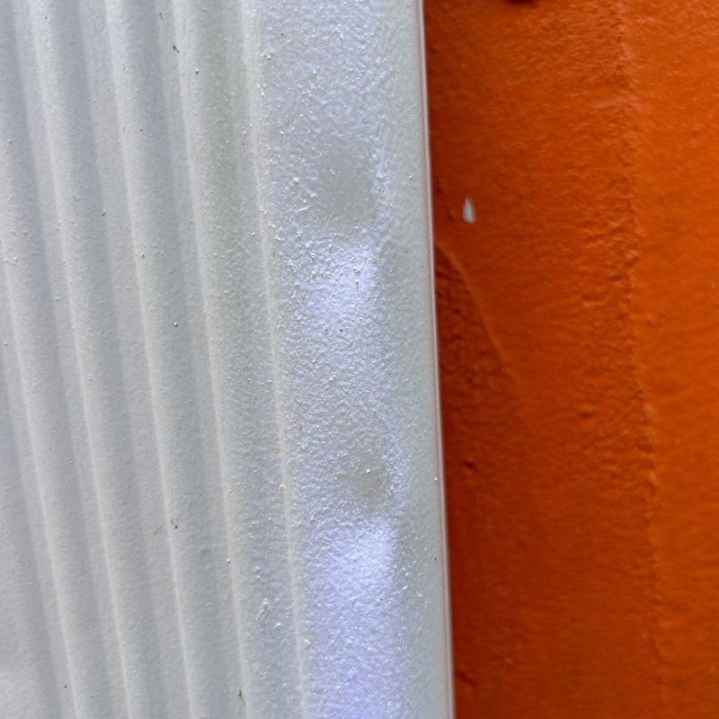 Metal siding with dents from hail damage
