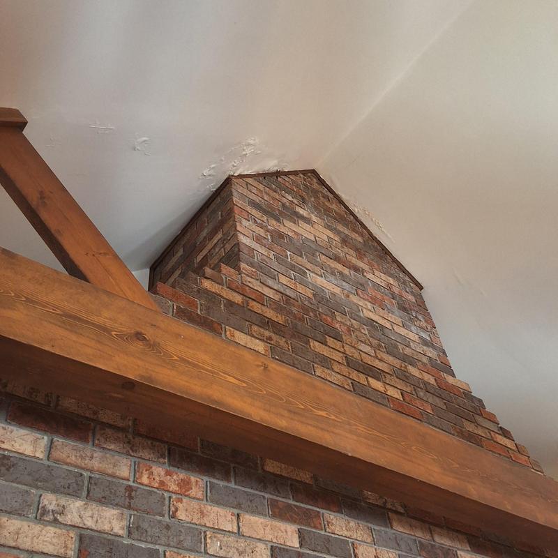 Chimney brickwork with ceiling water damage and wood beam Chimney brickwork with ceiling water damage and wood beam
