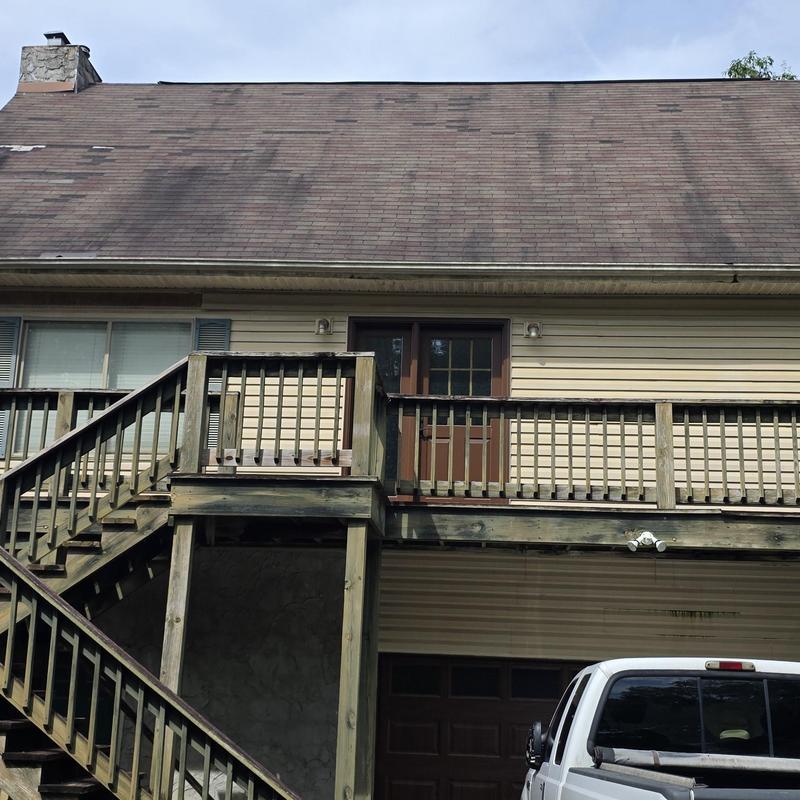 Asphalt shingle roof with visible wear and damage
