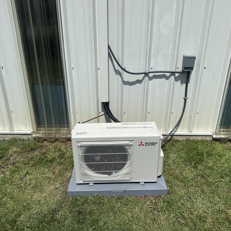 Mini split outdoor unit installed on concrete pad Mini split outdoor unit installed on concrete pad