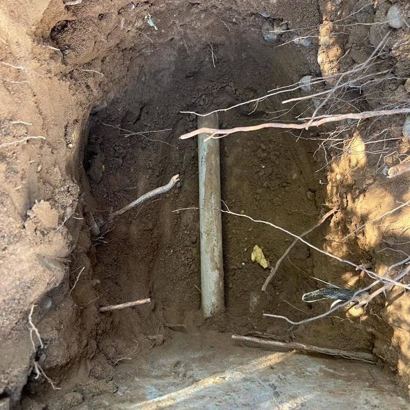 Main water service line exposed in excavation site