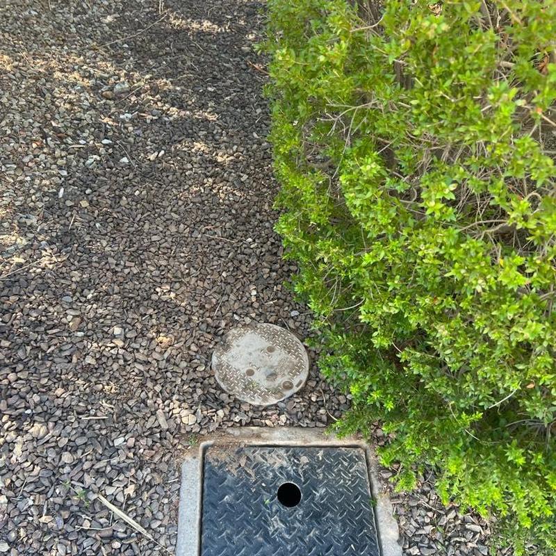 Pressure regulator valve with cover box and landscaping restored