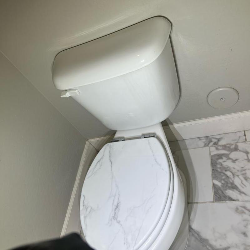 Toilet tank and bowl bolt installation in bathroom