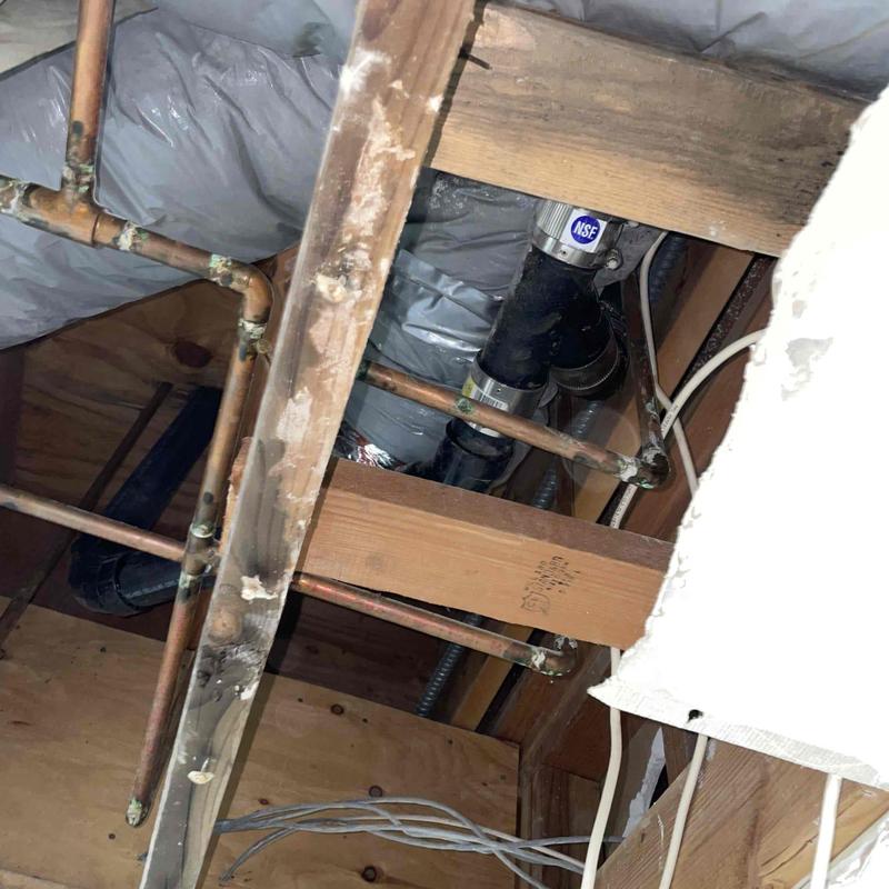 Cast iron drain pipe with ABS fittings in ceiling cavity Cast iron drain pipe with ABS fittings in ceiling cavity
