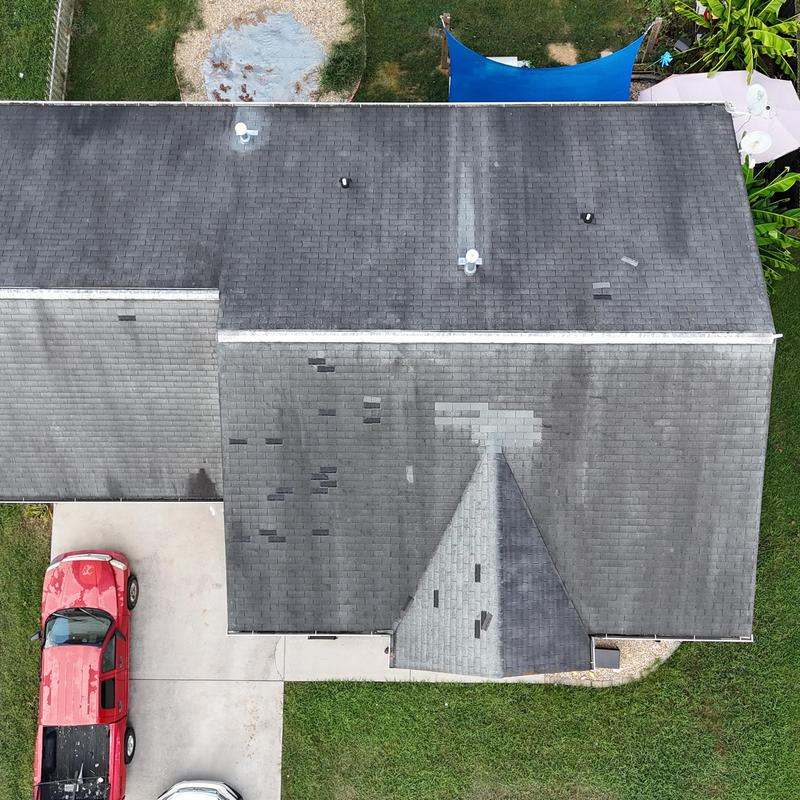 Asphalt shingle roof with patch repairs and wear Asphalt shingle roof with patch repairs and wear