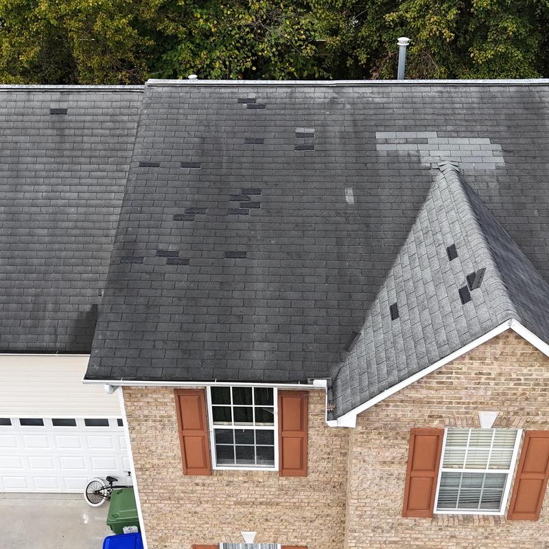 Asphalt shingle roof with patch repairs and wear Asphalt shingle roof with patch repairs and wear