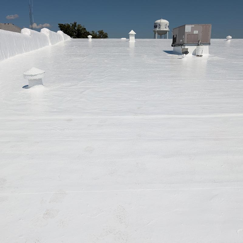 Elastomeric roof coating on flat commercial BUR roof
