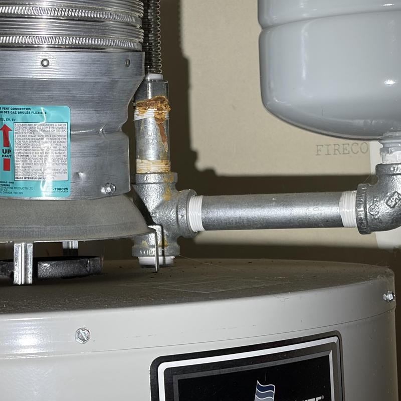 Galvanized pipe with brass fitting on water heater Galvanized pipe with brass fitting on water heater