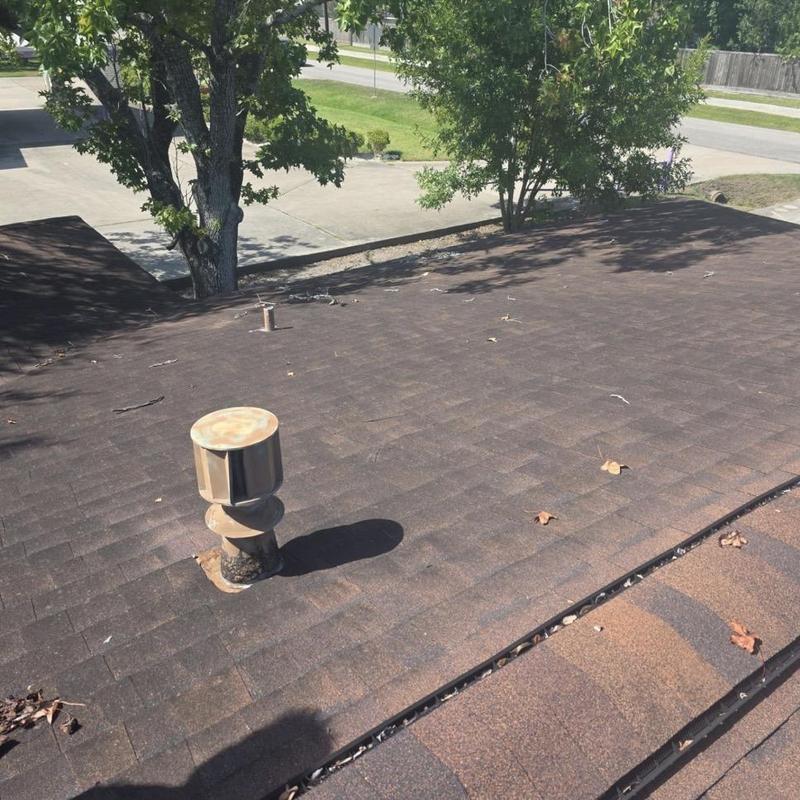Roof shingles with ventilation pipe and debris
