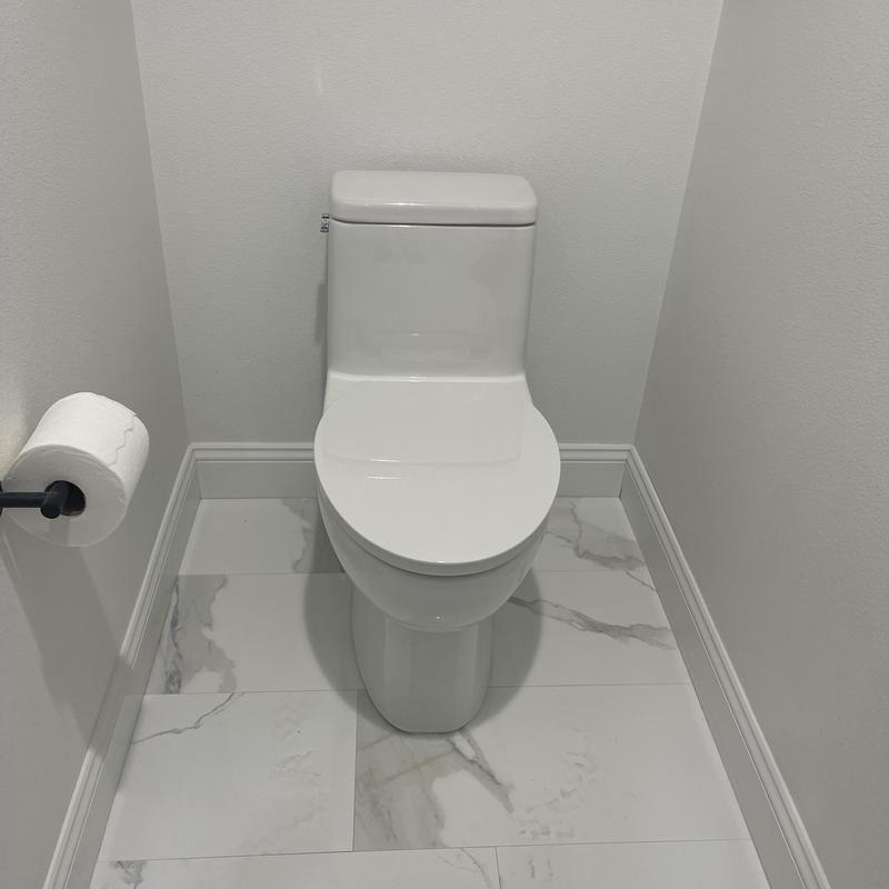 Standard toilet installed on marble tile floor Standard toilet installed on marble tile floor