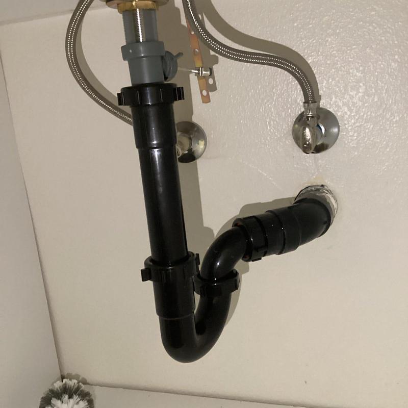 ABS drain pipe and fittings under bathroom sink ABS drain pipe and fittings under bathroom sink