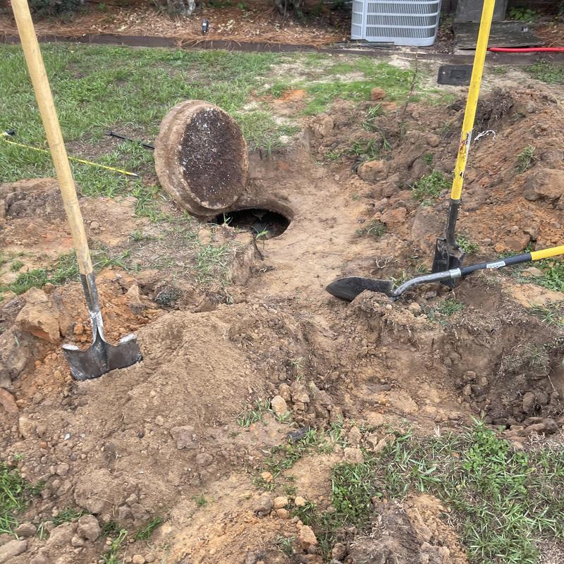 Mainline sewer access with soil excavation and tools Mainline sewer access with soil excavation and tools