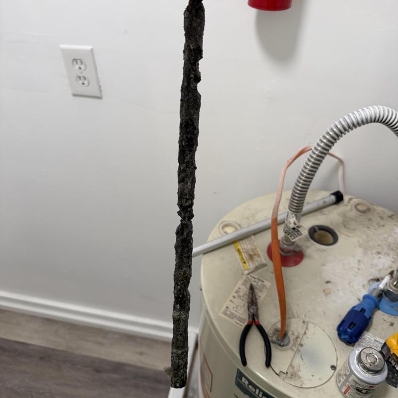 Anode rod removed from water heater tank Anode rod removed from water heater tank