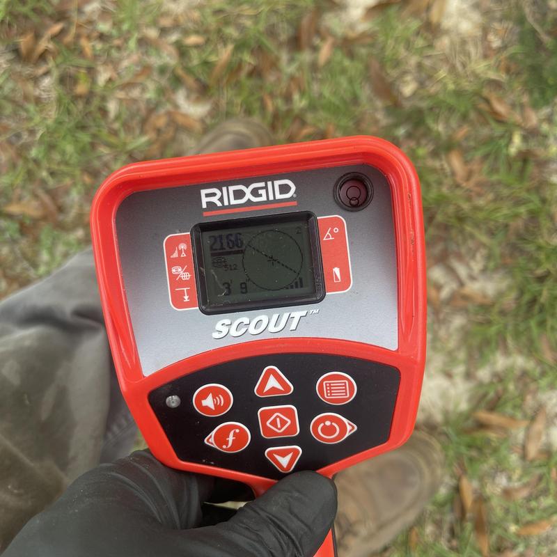 Sewer camera locator device RIDGID Scout in use outdoors Sewer camera locator device RIDGID Scout in use outdoors